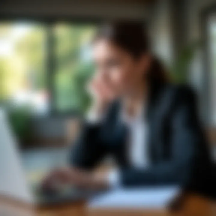 A young professional contemplating career options with a laptop and notepad.